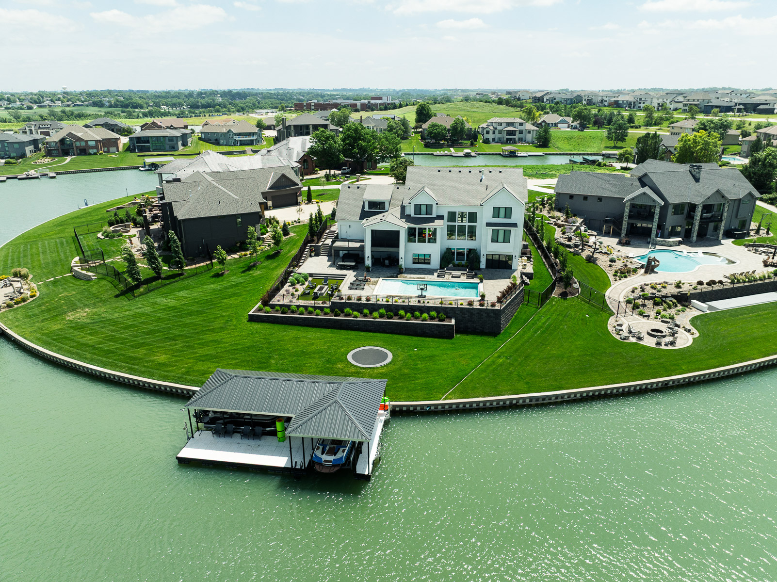 aerial marine dock trampoline retaining wall plants pool home