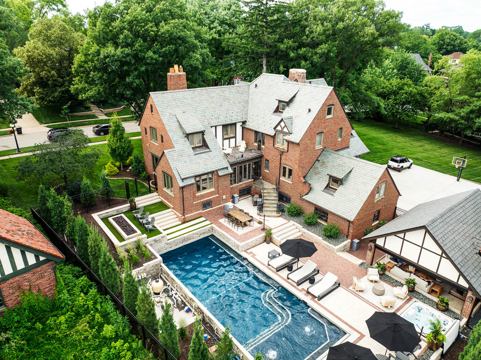 aerial pool tanning ledge patio seating firepit chairs home privacy plants hot tub stairs pergola