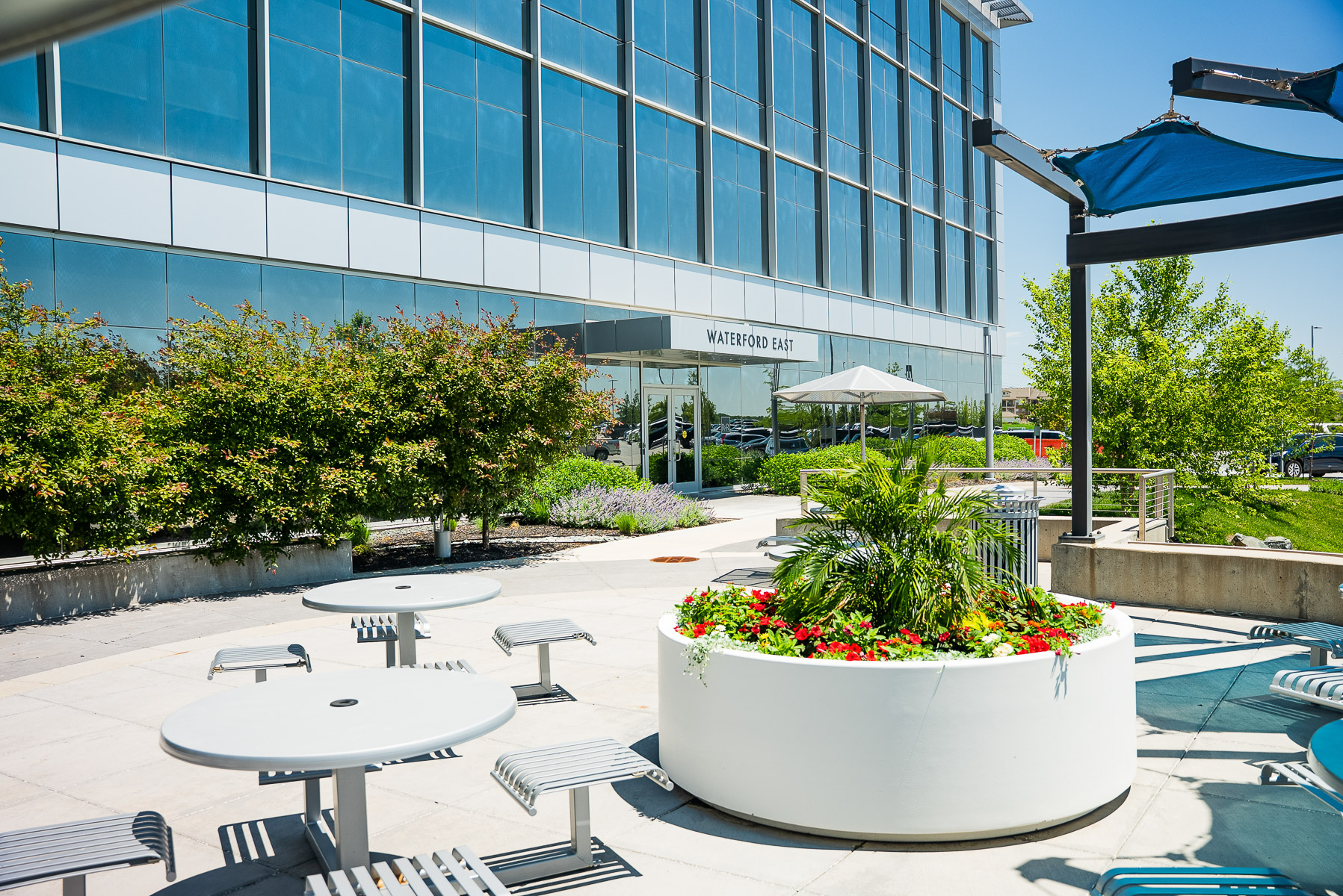commercial landscape outdoor seating area planting bed flowers tables break spot