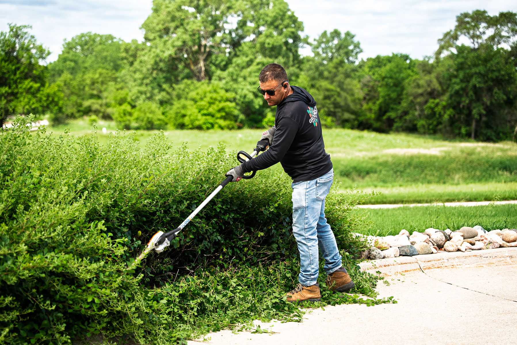 commercial maintenance crew hedge shears trimming