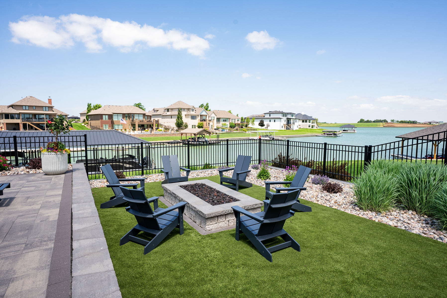 grass lawn adirondack chairs fire pit fencing