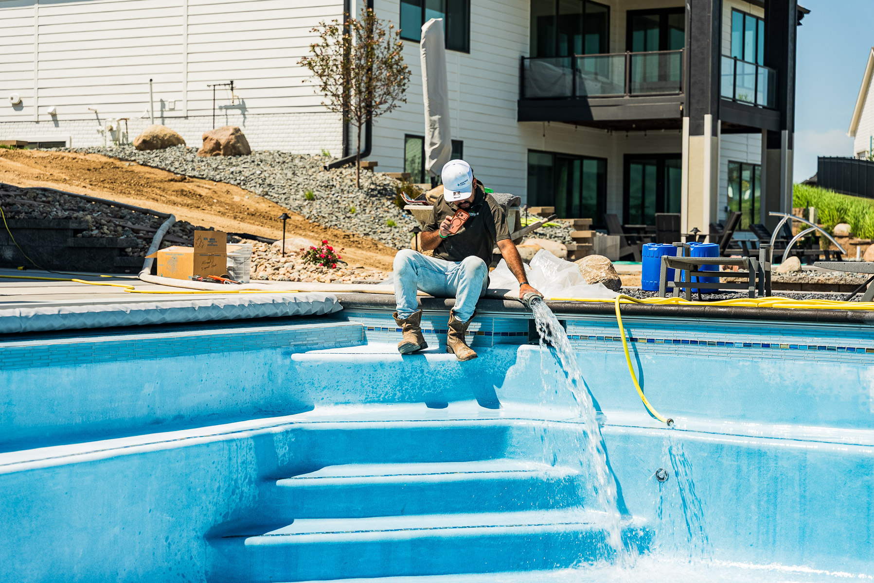 pool technician filling pool water 3