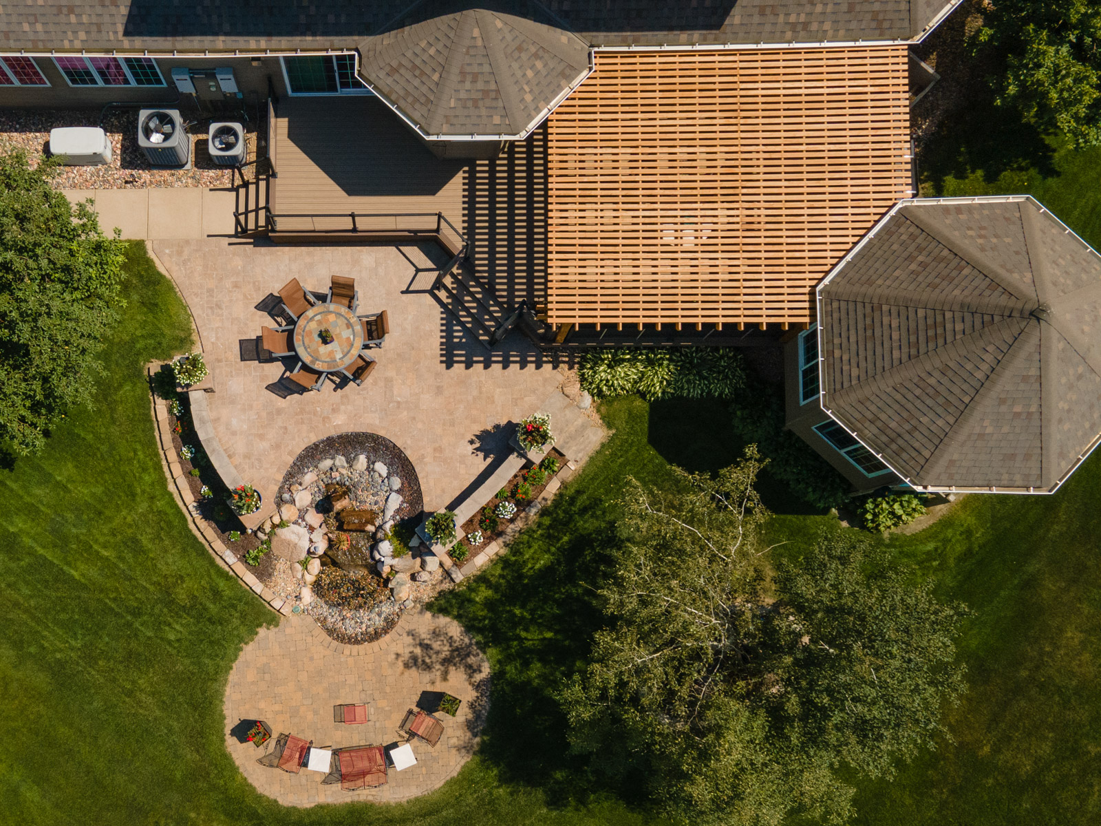 aerial pergola wood water feature seating table stone patio planting retaining wall deck