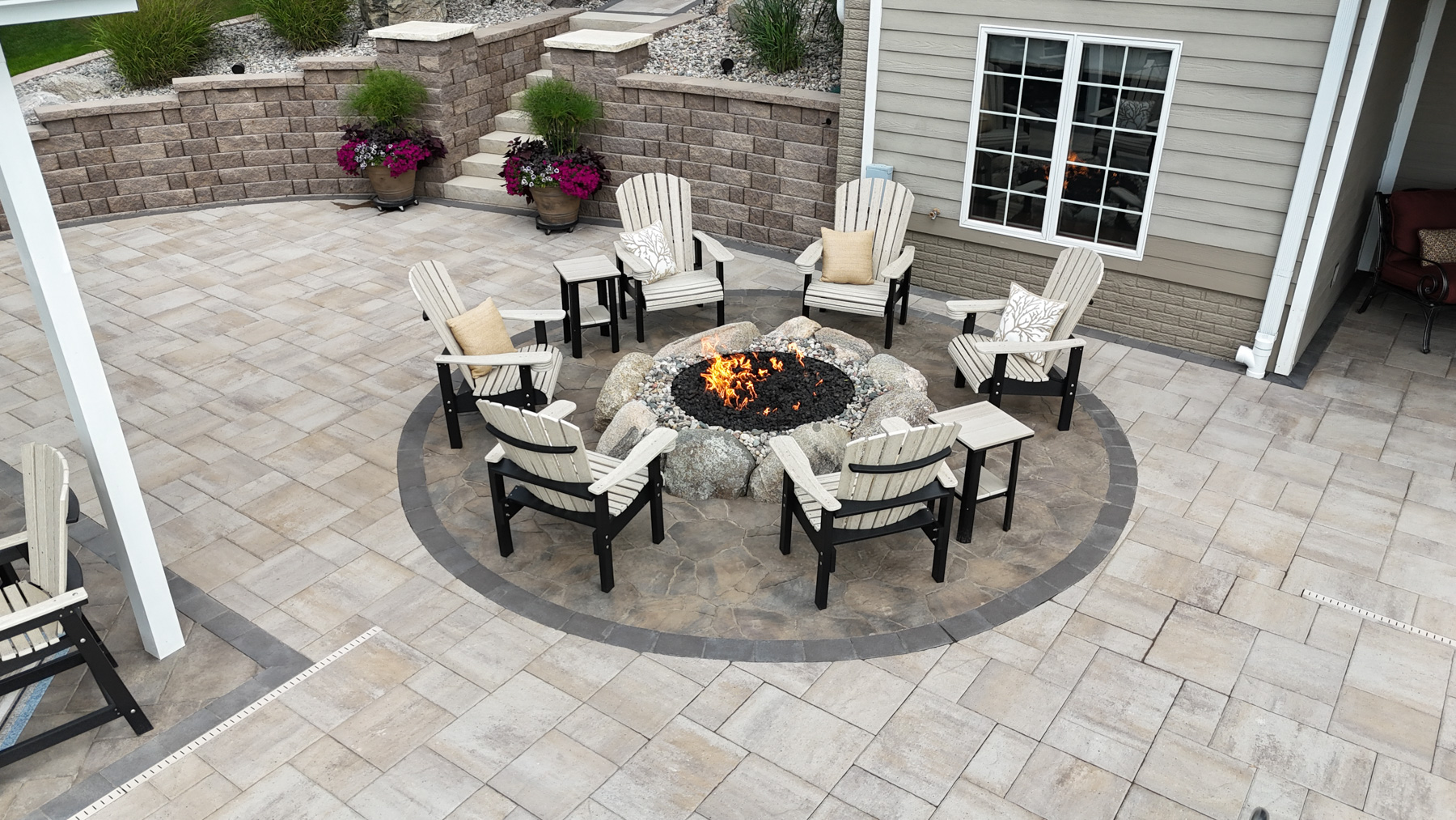 firepit seating area chairs stone patio pavers border