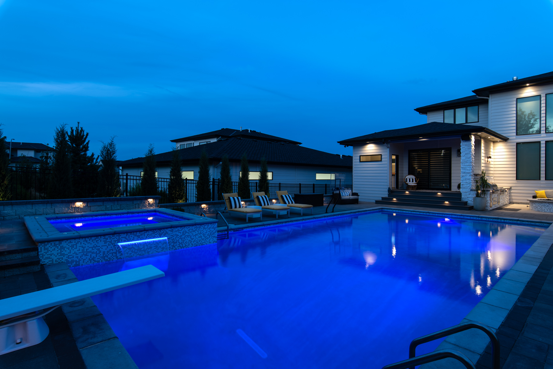 night landscape lights wall hot tub spa waterfall scupper pool diving boarsd seating home