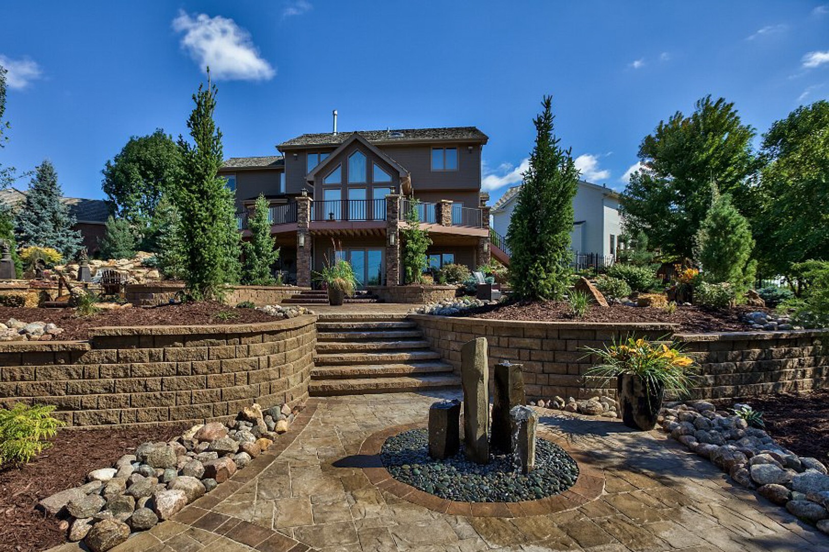 water feature basalt columns stone paver steps patio path retaining wall planting